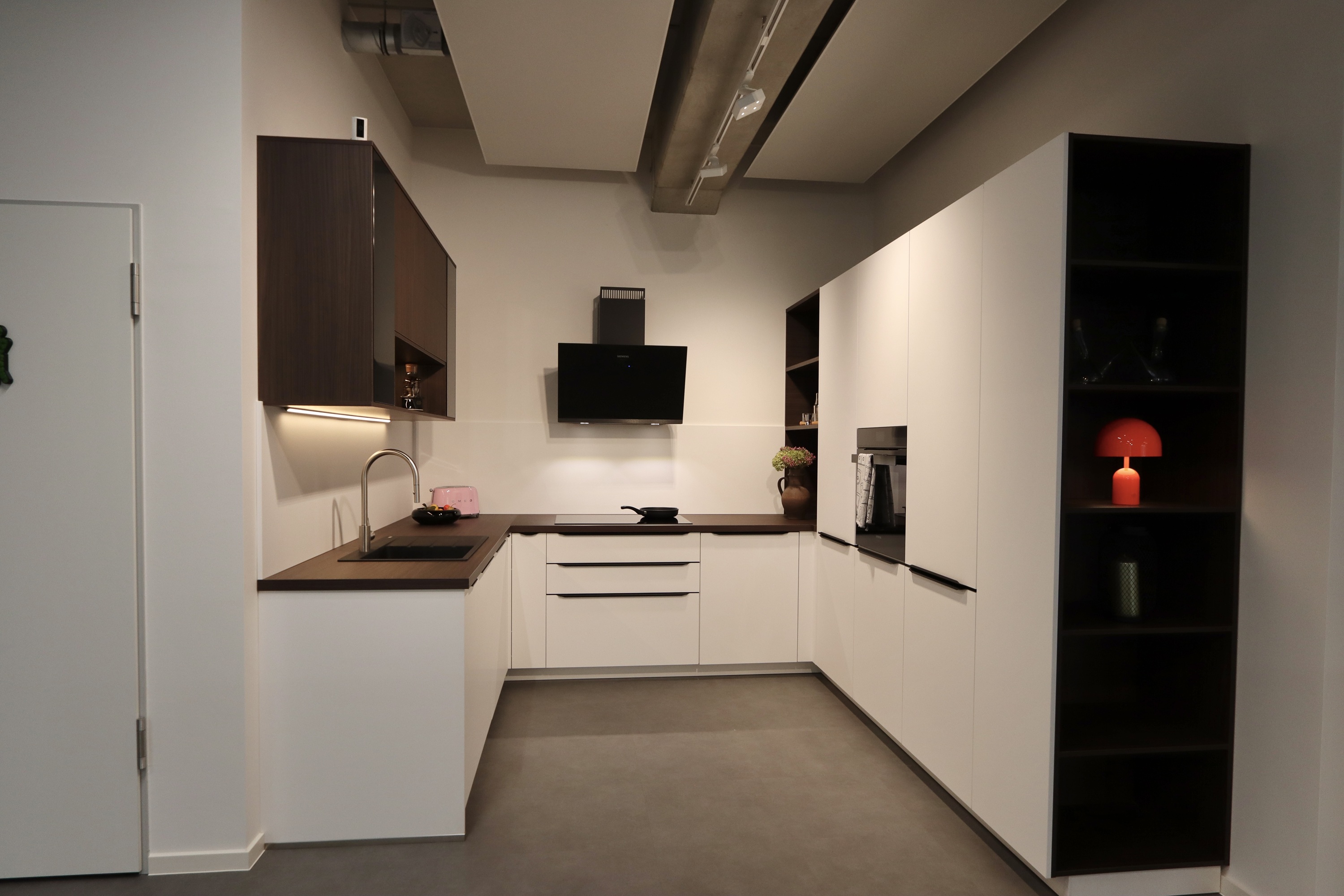 Nobilia Einbauküche mit weiß matten Lackfronten, kombiniert mit Nussbaum-Dekor und Siemens Studio-Line Geräten